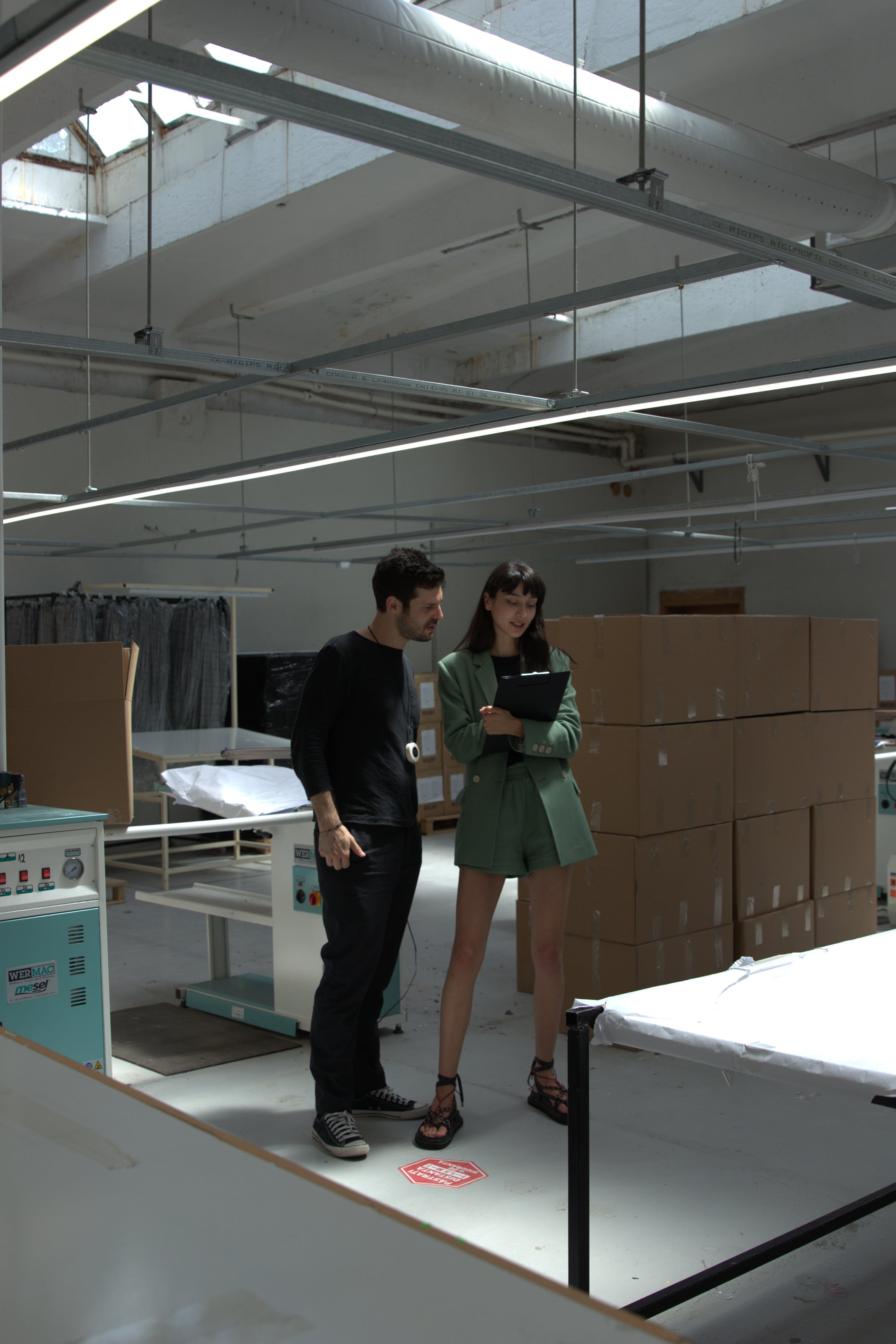 The bright industrial NOYOCO studio in Bucharest with garment racks and workstations